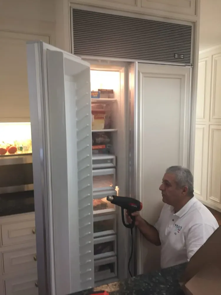 Eli Musayev servicing a built-in refrigerator — Spark Appliance Repair, Mountain View CA